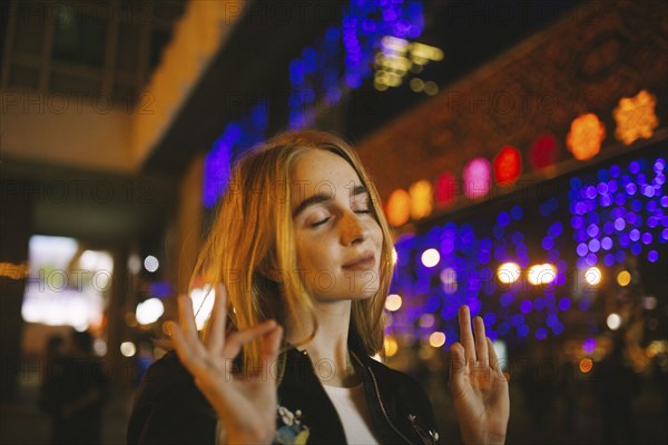 Caucasian woman listening to nightlife