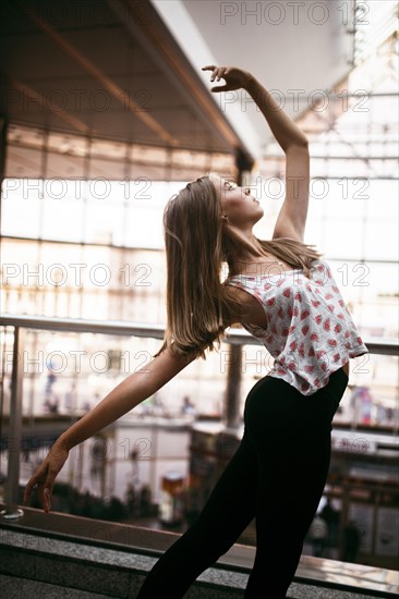 Caucasian woman dancing near railing