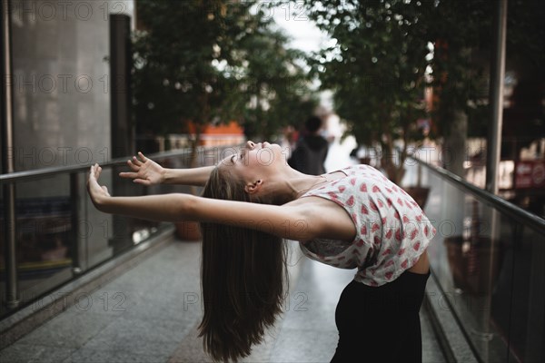 Caucasian woman dancing outdoors