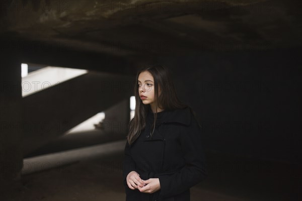 Pensive Caucasian woman wearing black coat