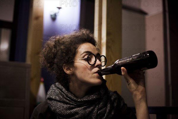 Caucasian woman drinking bottle of beer