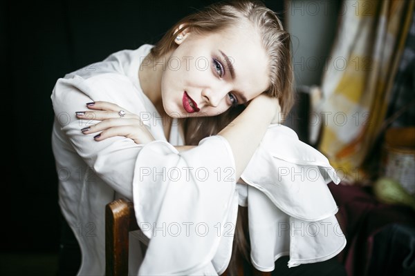 Portrait of smiling Caucasian woman leaning on chair