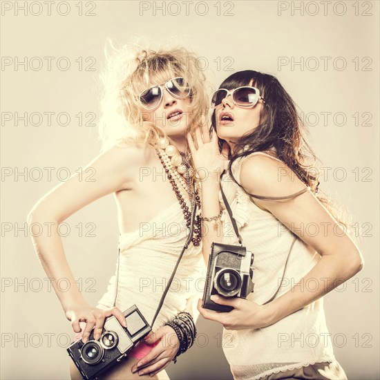 Caucasian women posing with cameras