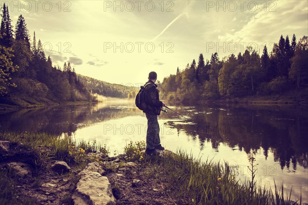 Caucasian man fishing at lakeside