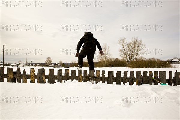 Caucasian boy playing in snow