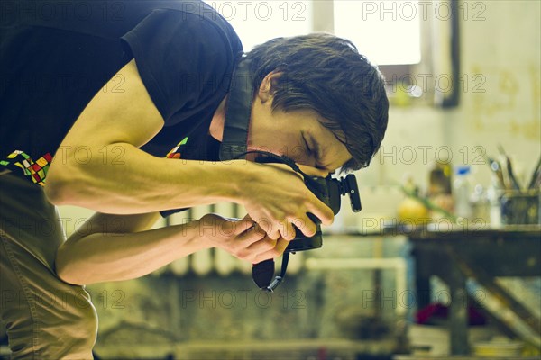 Caucasian photographer working in studio