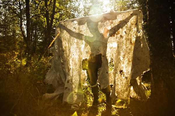 Caucasian man holding fabric outdoors