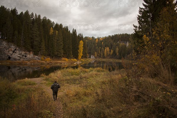 Caucasian man walking in rural landscape