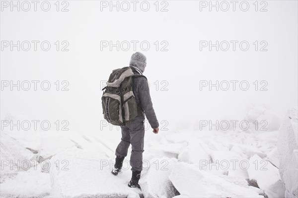 Caucasian man hiking in snow