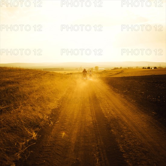 Dirt bikers driving on rural road