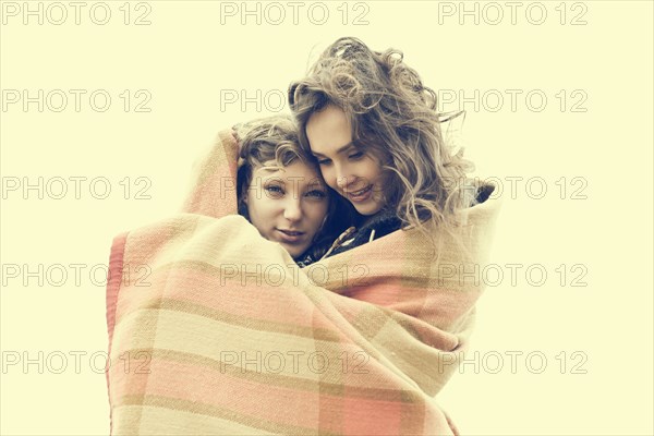 Caucasian women wrapped in blanket