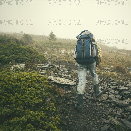 Mari man hiking on rocky hillside