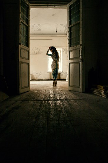 Caucasian woman standing in dilapidated house