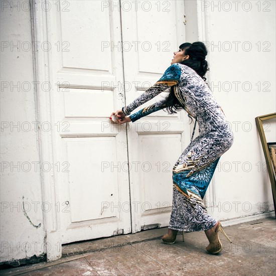 Caucasian woman trying to open locked door