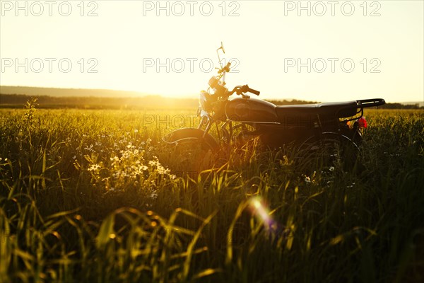 Motorcycle parked in rural field