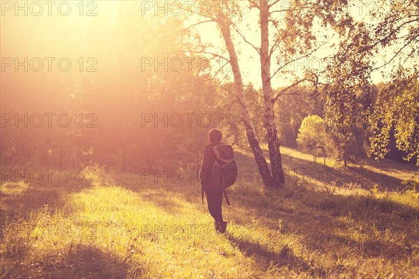 Mari man carrying backpack in rural field