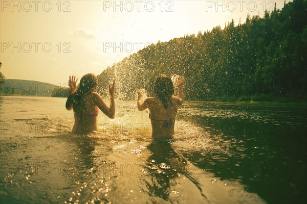 Children splashing in lake