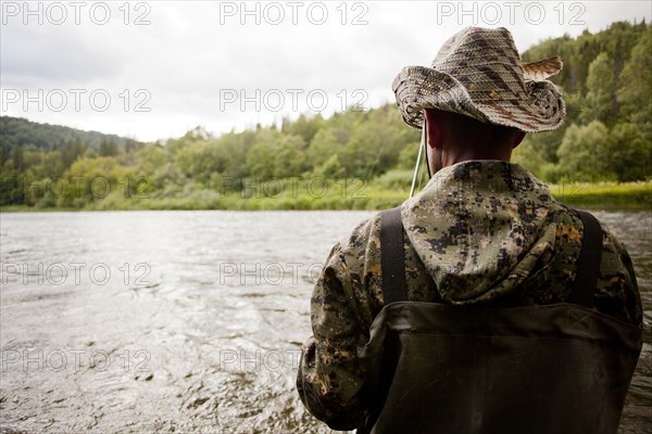 Mari man fishing in river