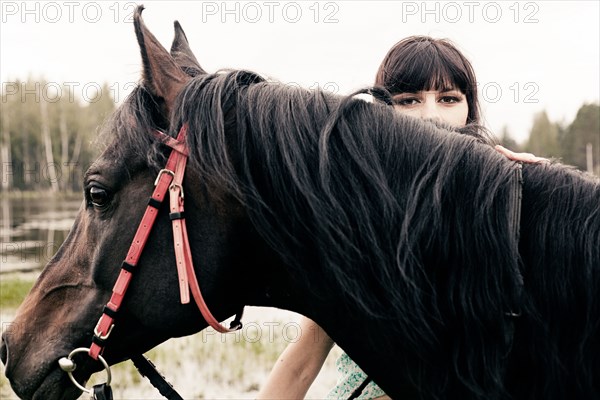 Caucasian woman with horse outdoors