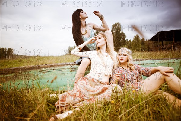 Caucasian women relaxing in field