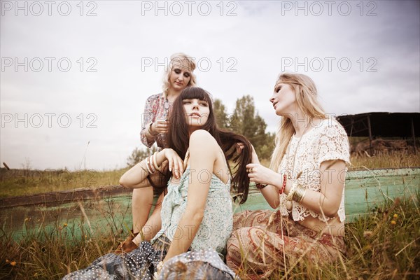 Caucasian women relaxing in field