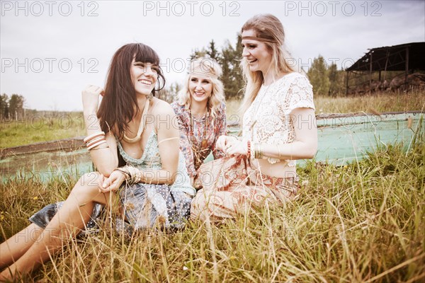 Caucasian women laughing in field