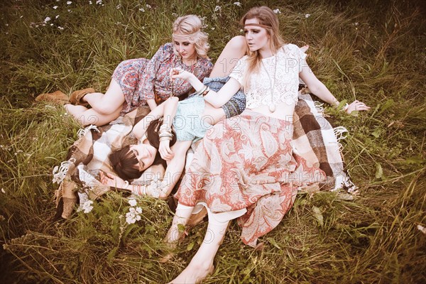 Caucasian women relaxing in field