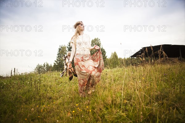 Caucasian woman walking in field