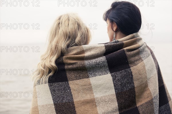 Caucasian women wrapped in blanket outdoors