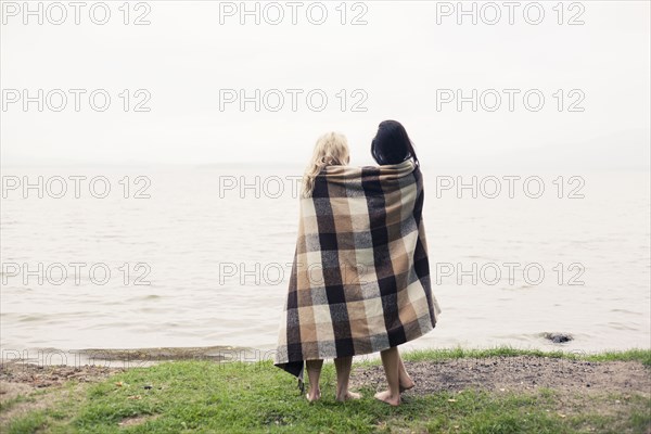 Caucasian women wrapped in blanket outdoors