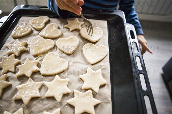 Mari boy baking cookies in kitchen