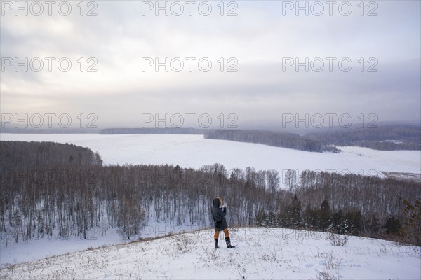Caucasian woman standing on snowy hilltop