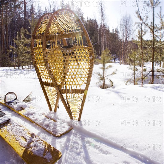 Close up of snowshoes and skis in snowy field