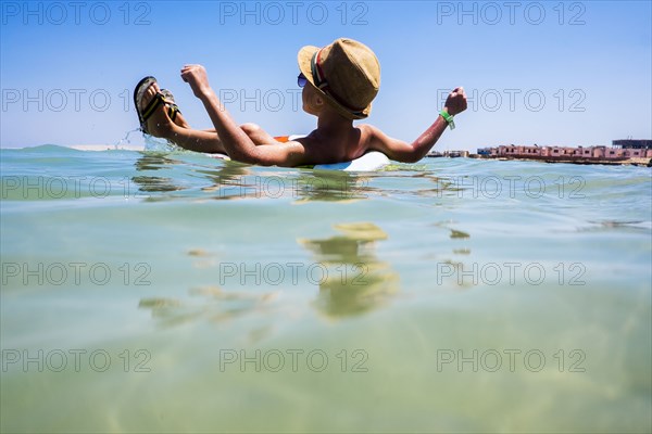 Mari boy floating in inflatable ring in ocean