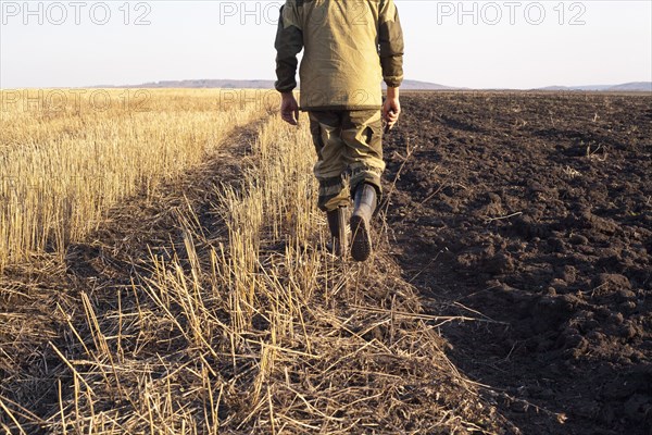 Mari farmer walking in crop fields
