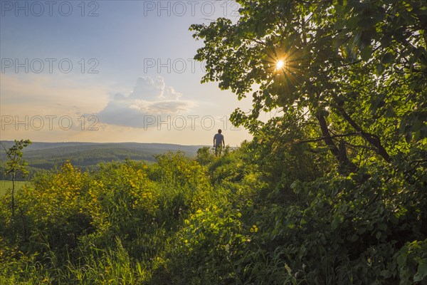 Mari man walking in rural landscape