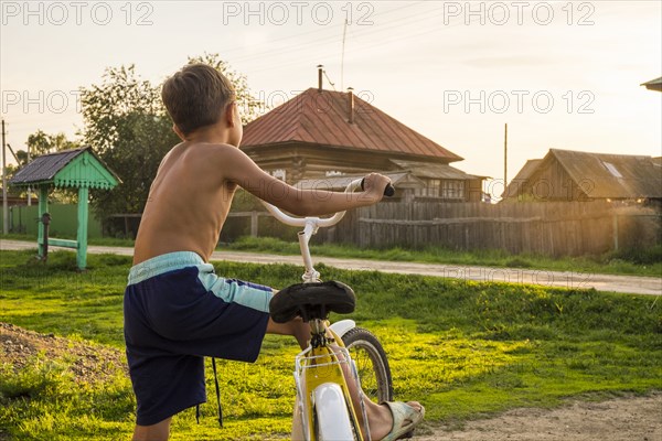 Mari boy riding bicycle