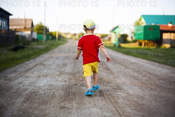 Mari boy walking on dirt path