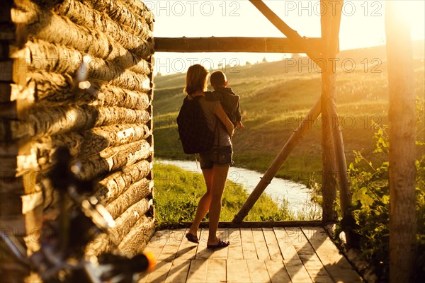 Mother holding son on patio