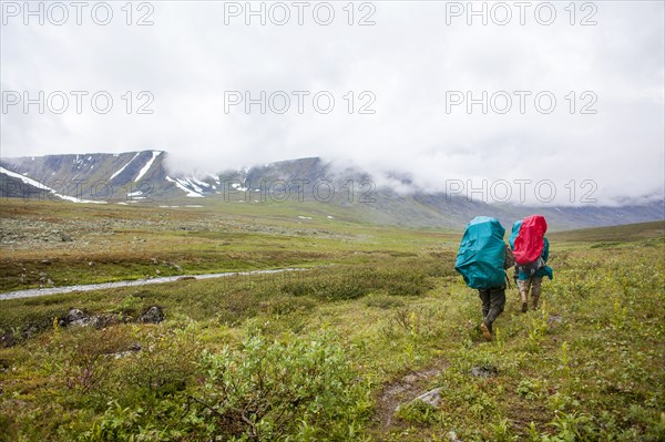 Backpackers walking on rural path