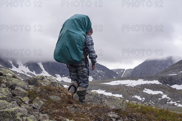 Mari backpacker walking on mountain path