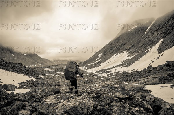 Mari backpacker walking in mountain valley