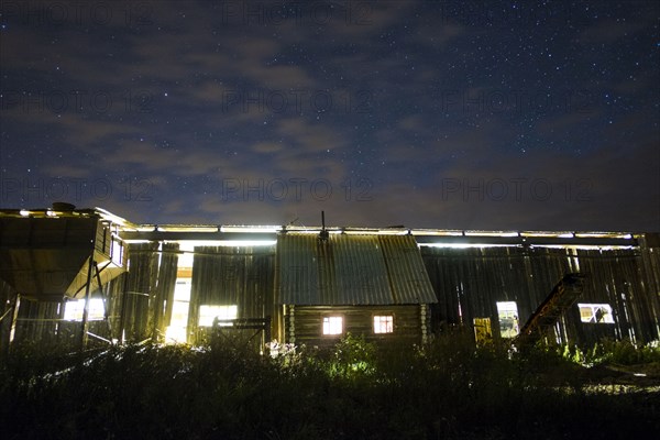 Illuminated cabin under morning sky