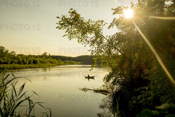 Distant Mari man fishing on lake