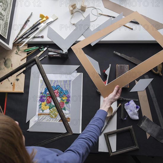 Caucasian woman holding mat for picture frame