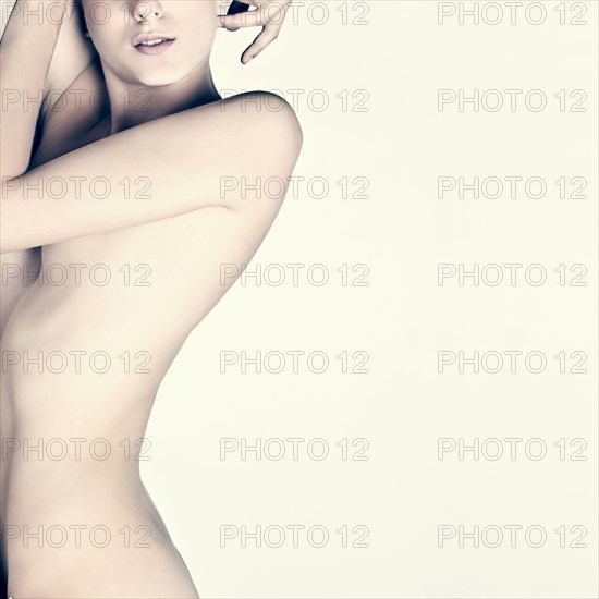 Midsection of naked Caucasian woman