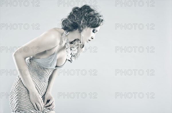Curious Caucasian woman wearing sheer dress looking down