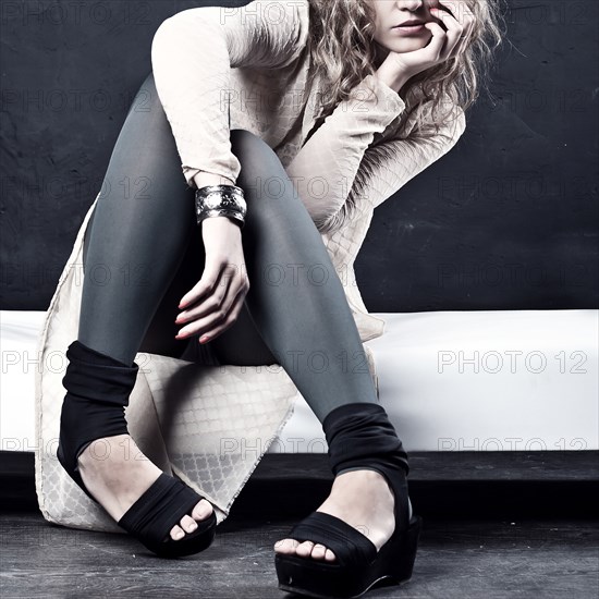 Pensive Caucasian teenage girl wearing high heels