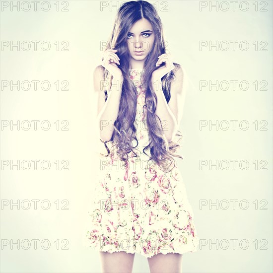 Portrait of Caucasian teenage girl holding hair