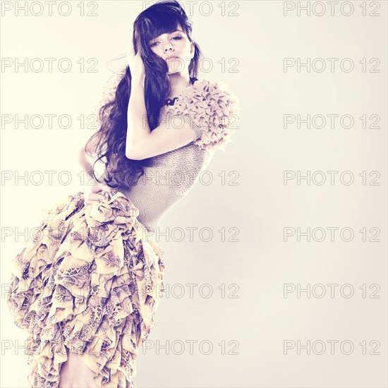 Serious Caucasian woman wearing ruffled skirt